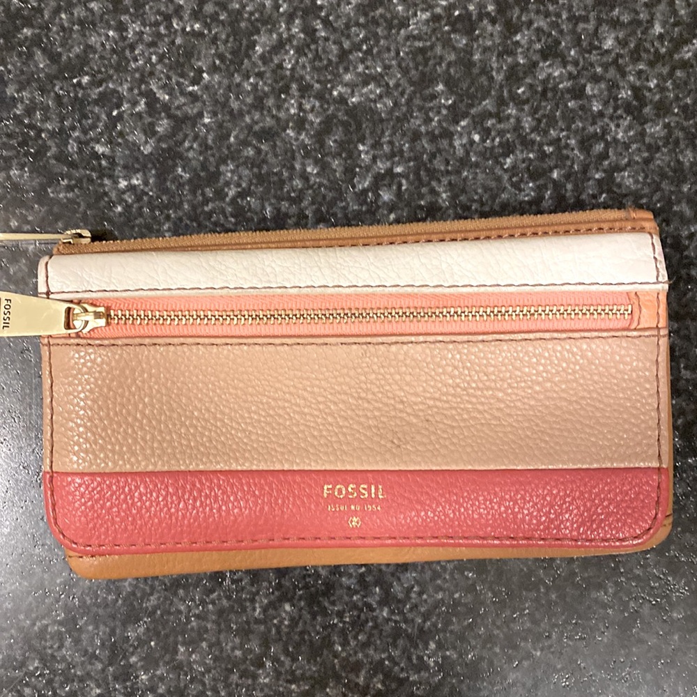 FOSSIL wallet. It’s in a very happy coral, tan and cream color combo.